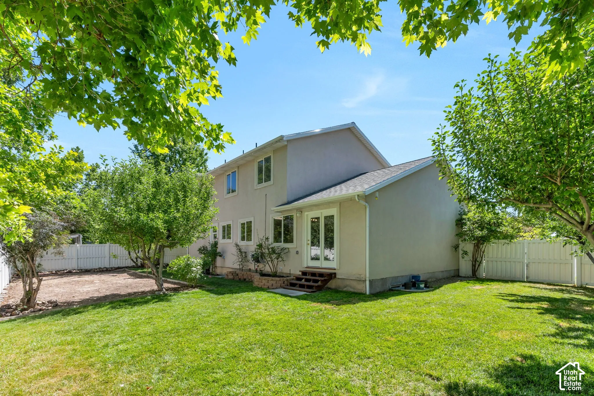 Expansive green lawn bordering a stucco exterior