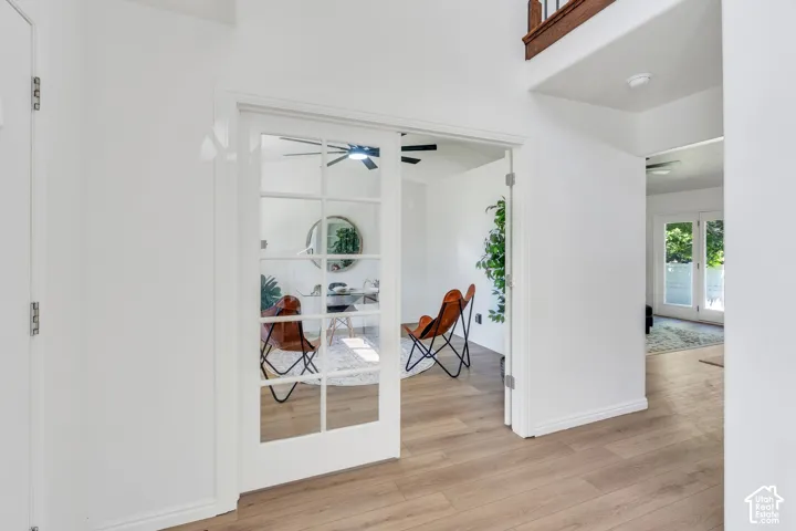 French doors with multiple lites opening into a bright interior space