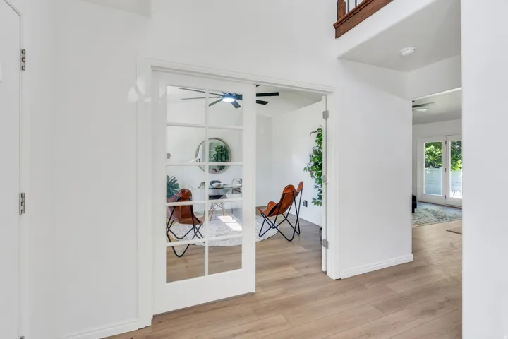 French doors with multiple lites opening into a bright interior space