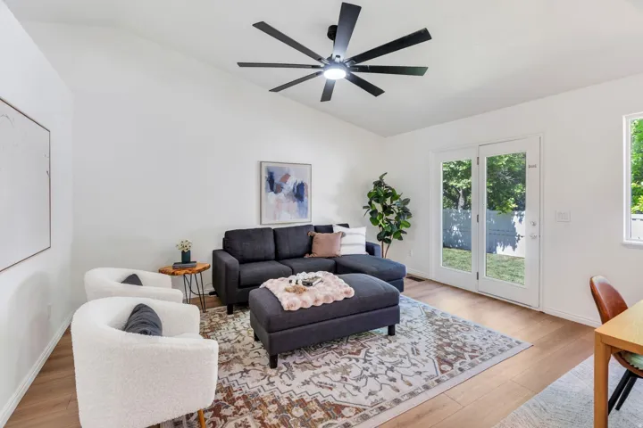 Vaulted ceilings complementing abundant natural light from double-pane glass doors and a large window