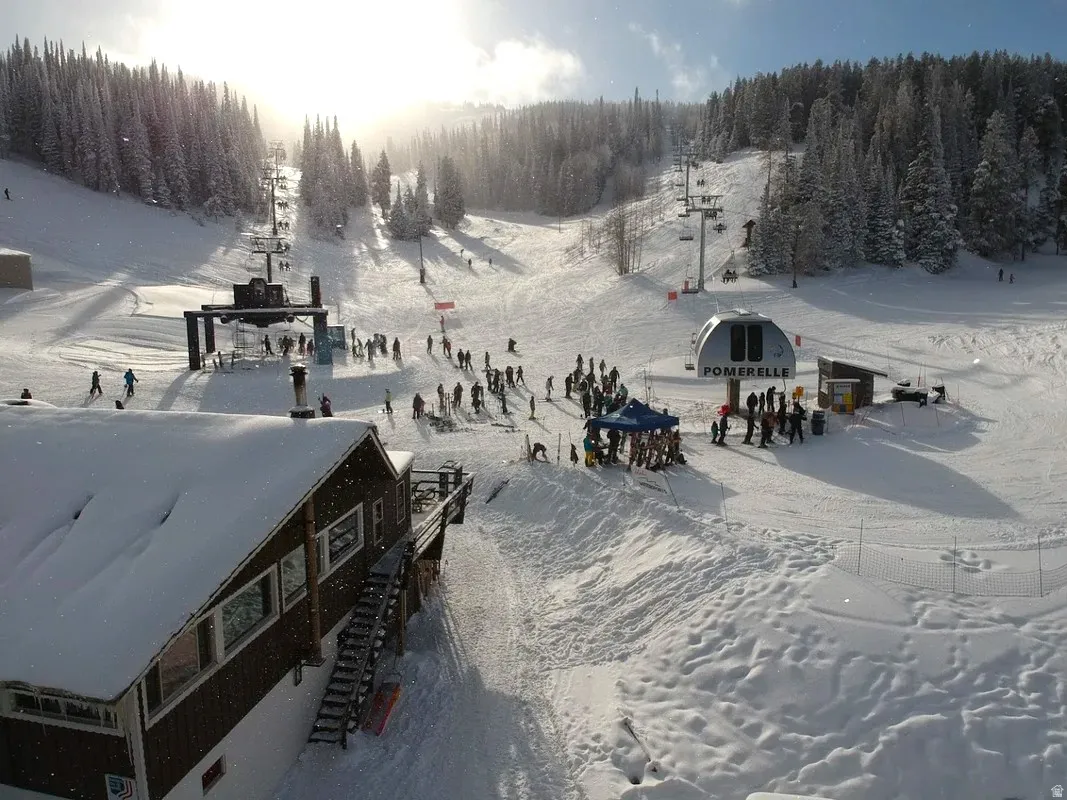 Ski-in/ski-out lodge with a snow-covered roof and a prominent outdoor deck