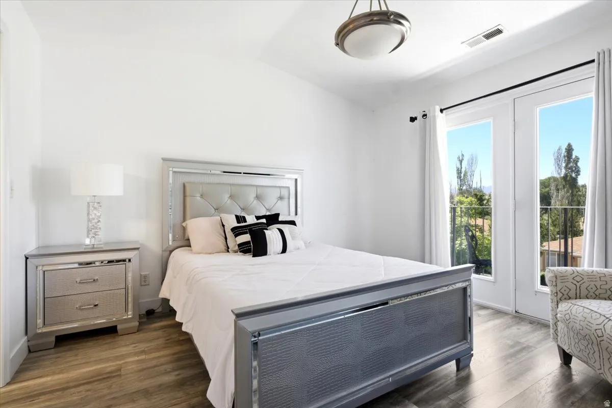 Bedroom featuring wood-finish flooring and white walls