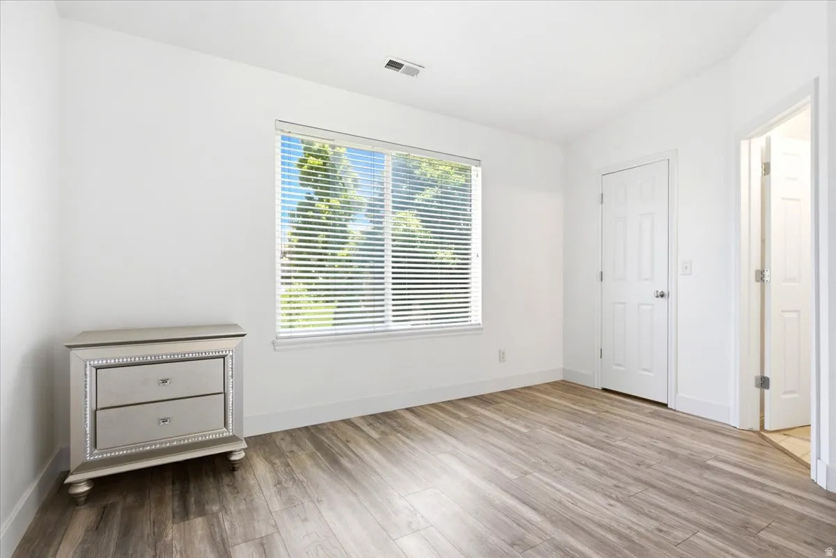 Bright interior space featuring wood-finish flooring, white walls, and white trim