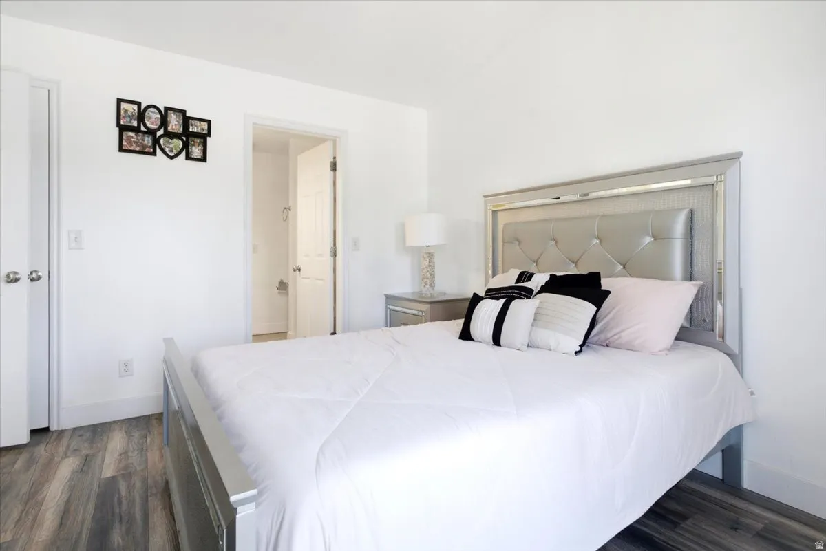 Bright bedroom with clean white walls and wood-finish flooring