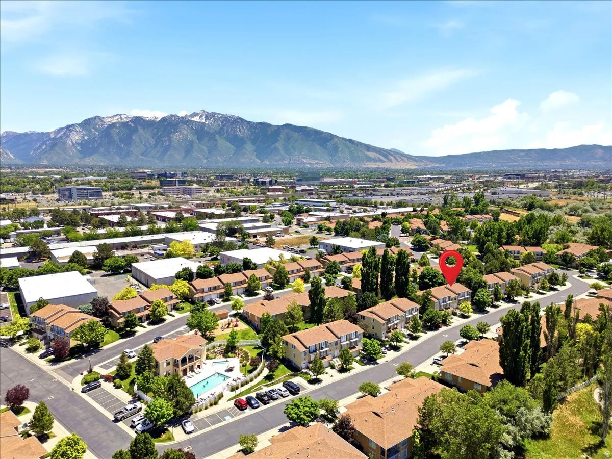 Aerial perspective showcasing a residential community with multi-story buildings and mature trees