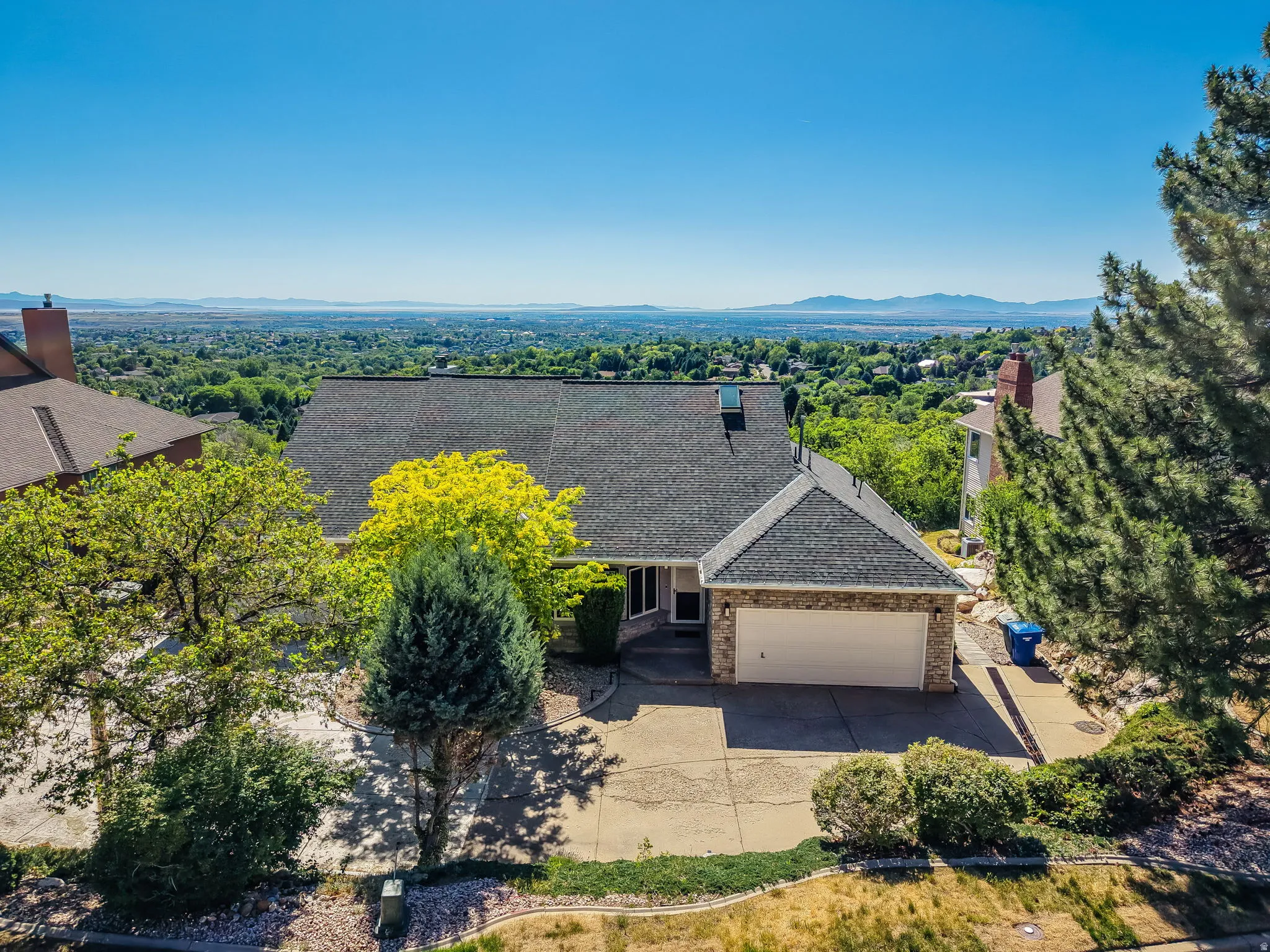 Single-family residence featuring a dark shingle roof, attached two-car garage, and a concrete driveway