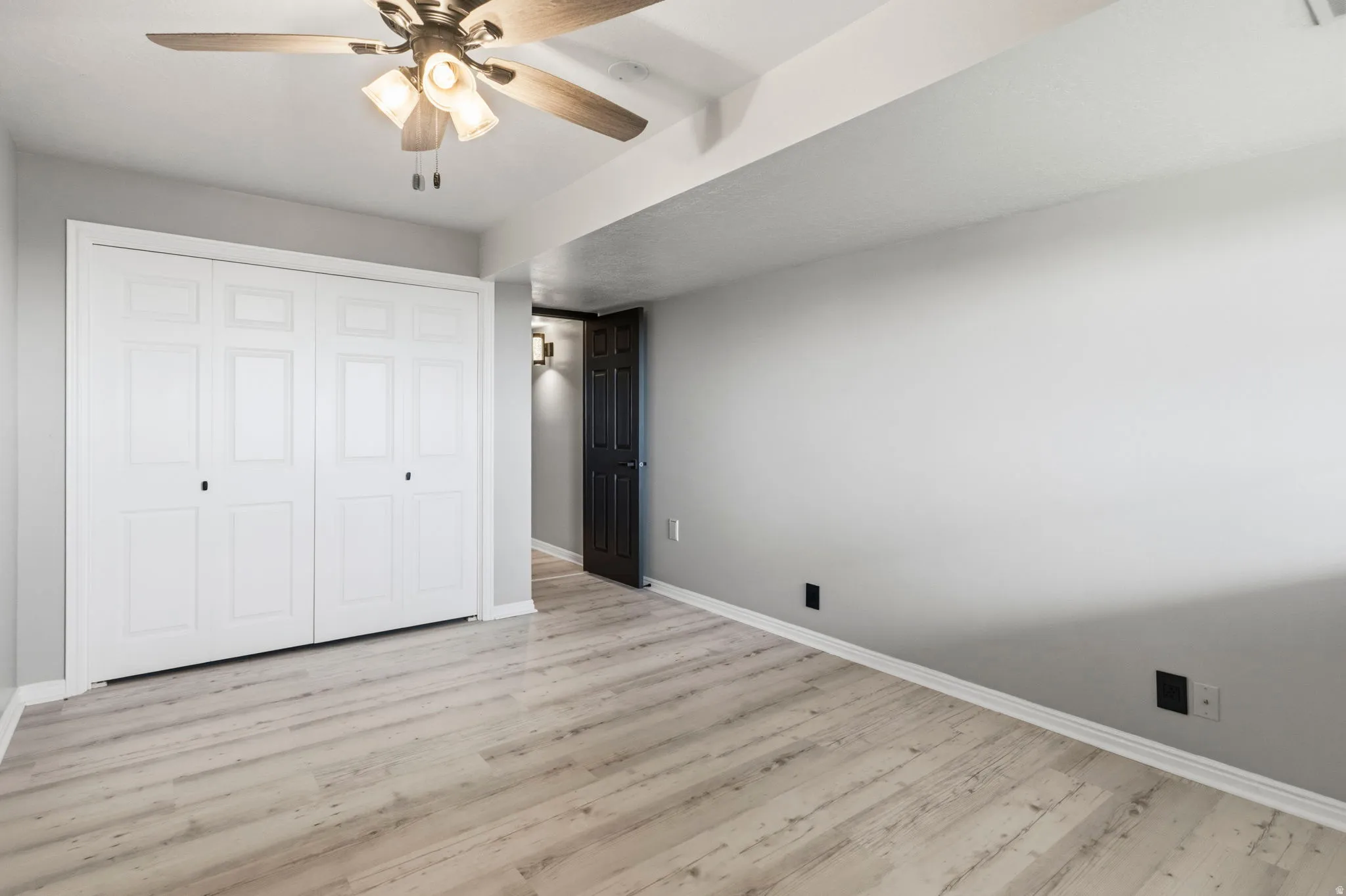Recessed lighting, wood-finish flooring, white panel bi-fold closet doors, and a ceiling fan with integrated lighting