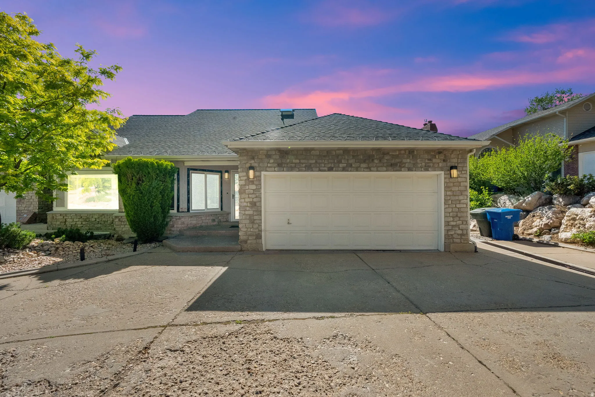 Stone veneer facade with an attached two-car garage