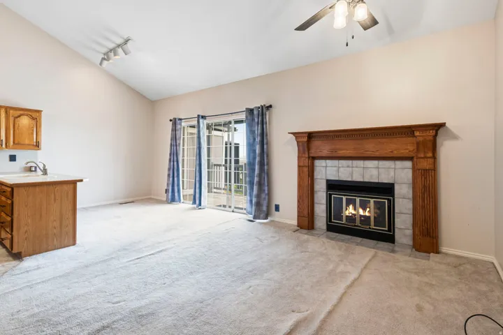 Vaulted ceiling with track lighting and a ceiling fan