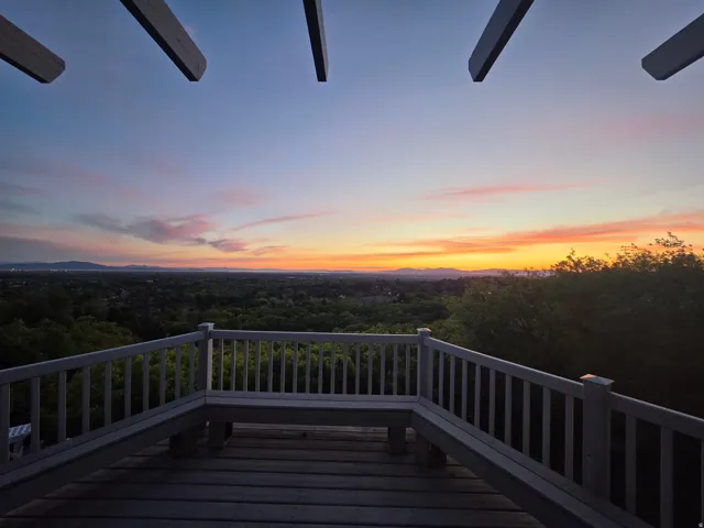 Outdoor deck featuring wood-finish flooring and a built-in bench