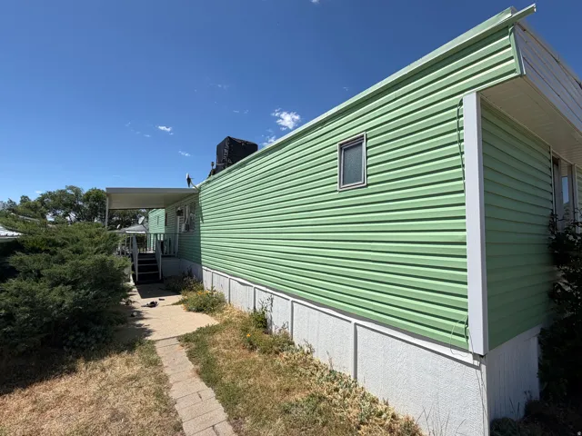 Light green horizontal siding with white trim