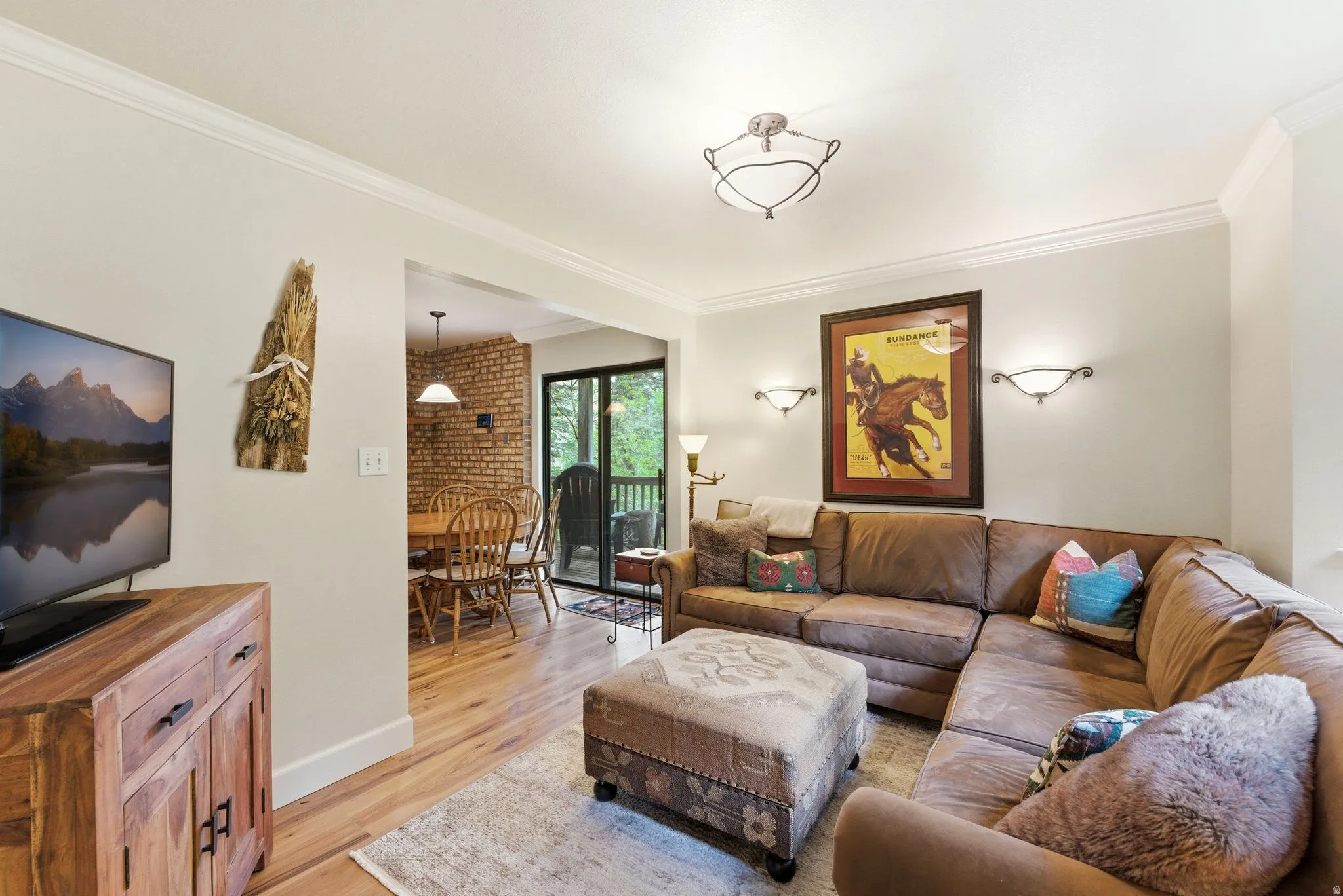 Living area featuring crown molding and light-colored walls