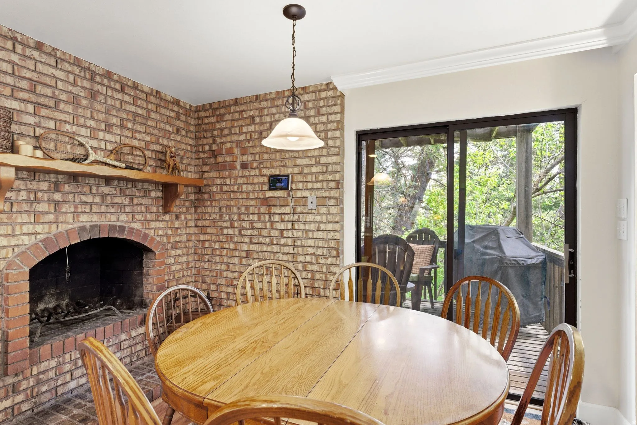 Brick-clad fireplace with wood mantle and hearth