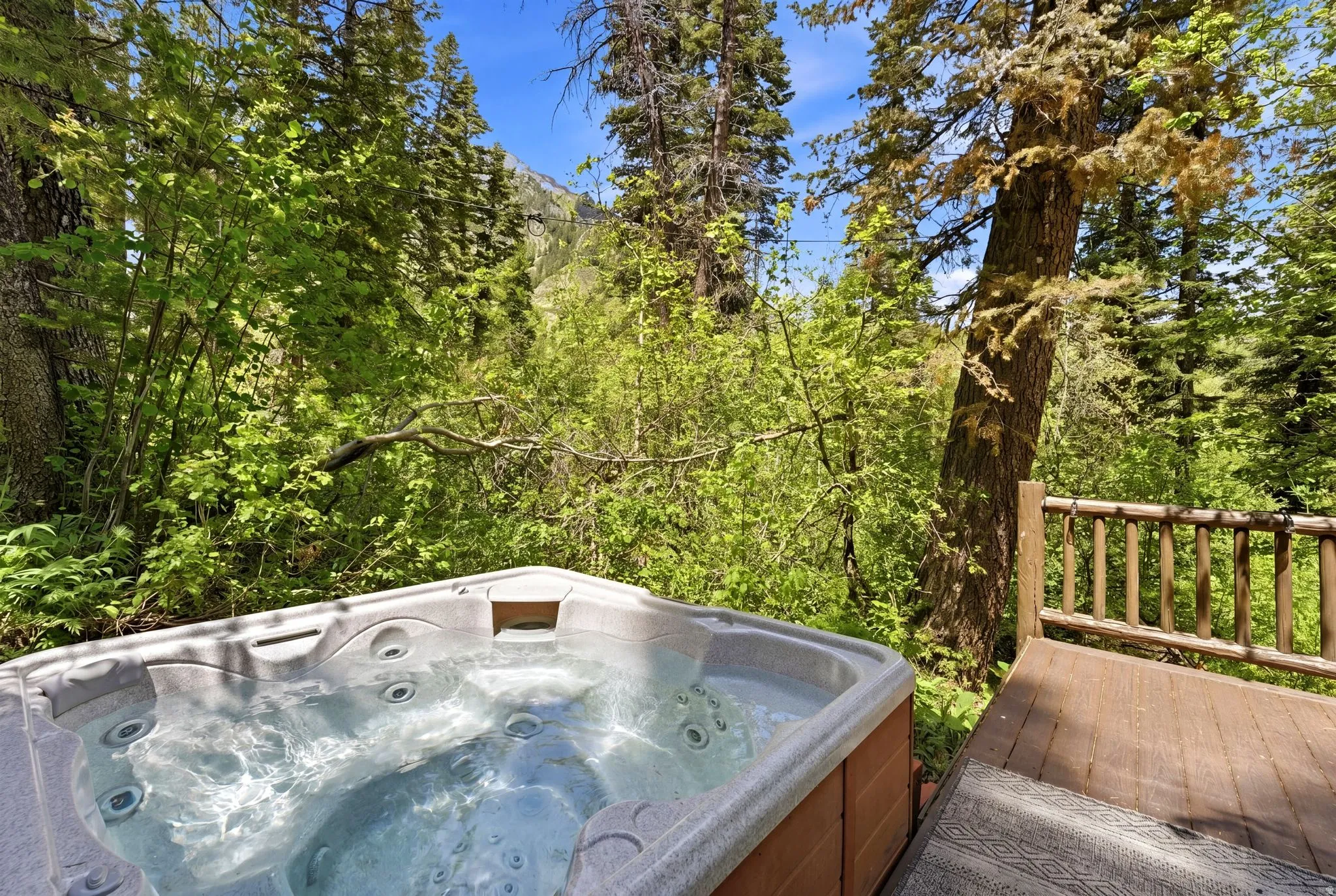 Outdoor hot tub featuring built-in seating, a durable exterior finish, and clear water