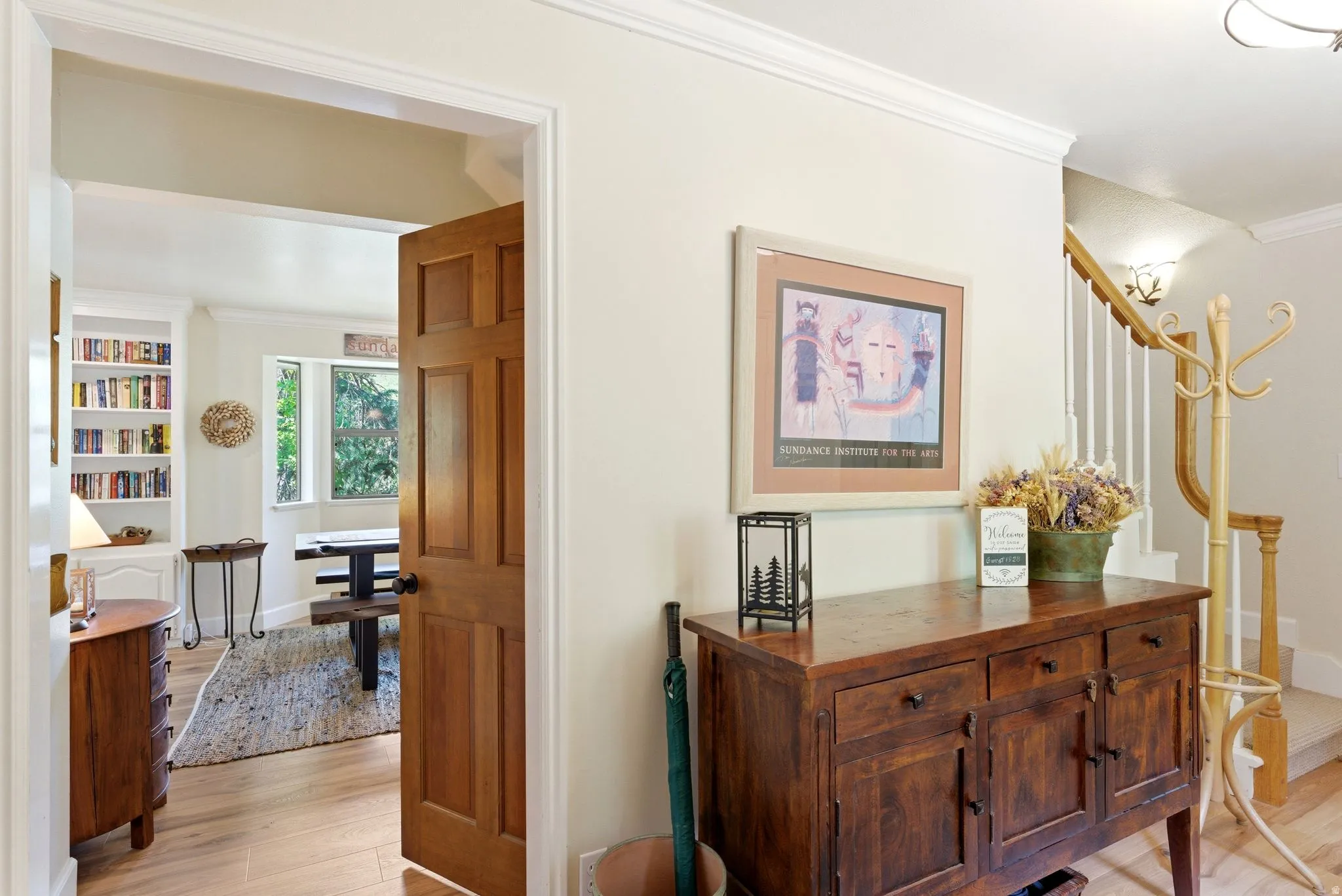 Entryway featuring crown molding and a paneled wooden door
