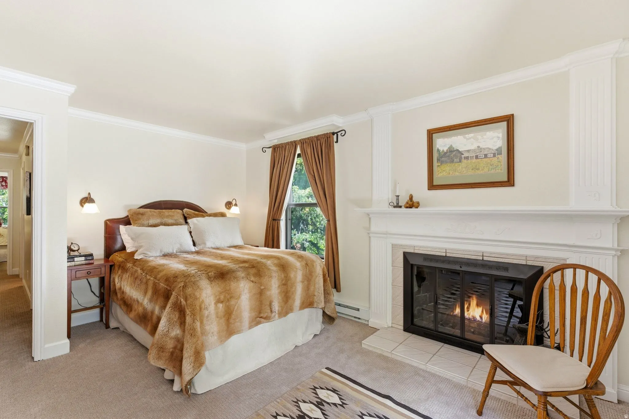 Carpeted room featuring crown molding, a window with drapery, and a fireplace with a white mantel and tile surround