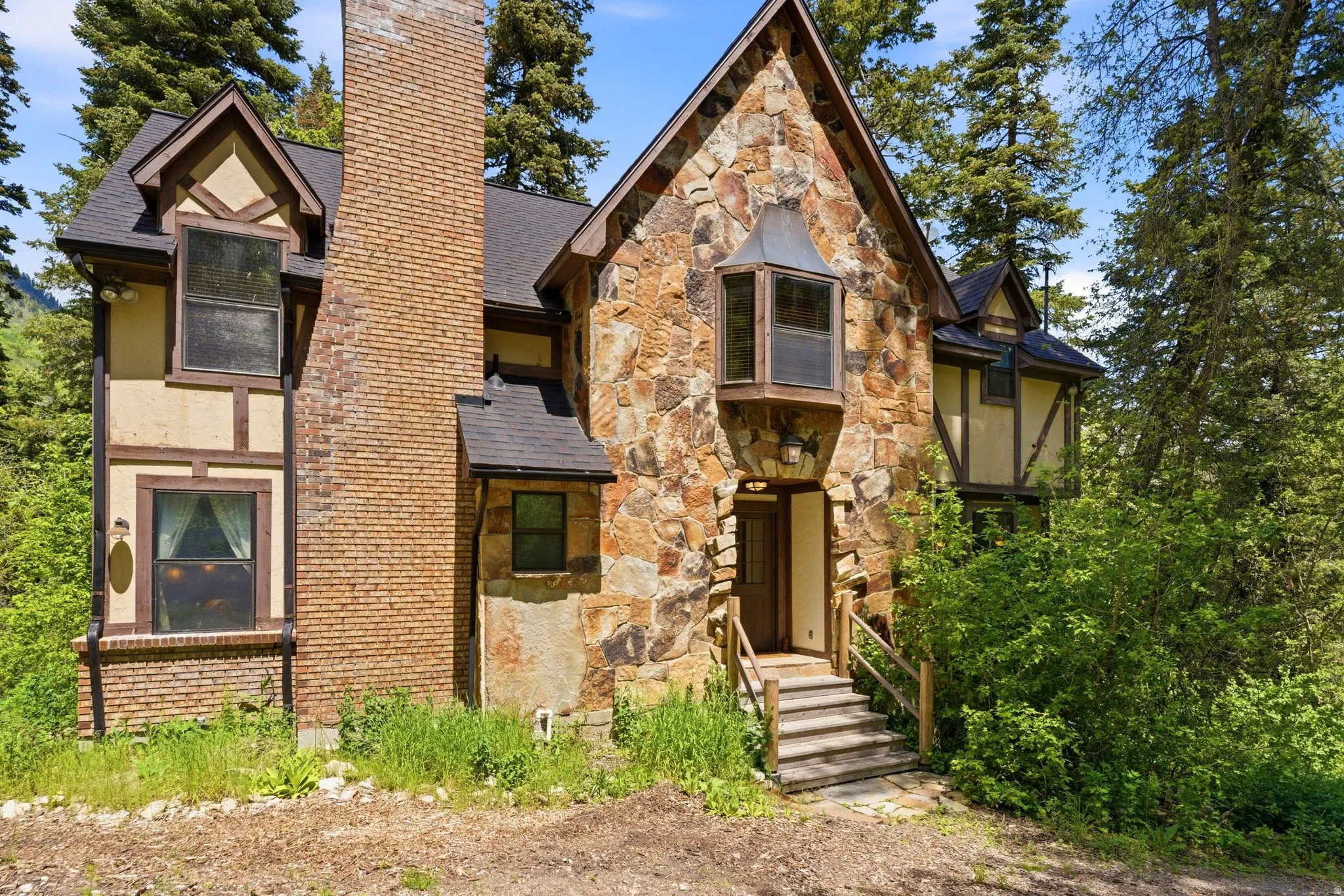 Stone and half-timber facade featuring a prominent brick chimney