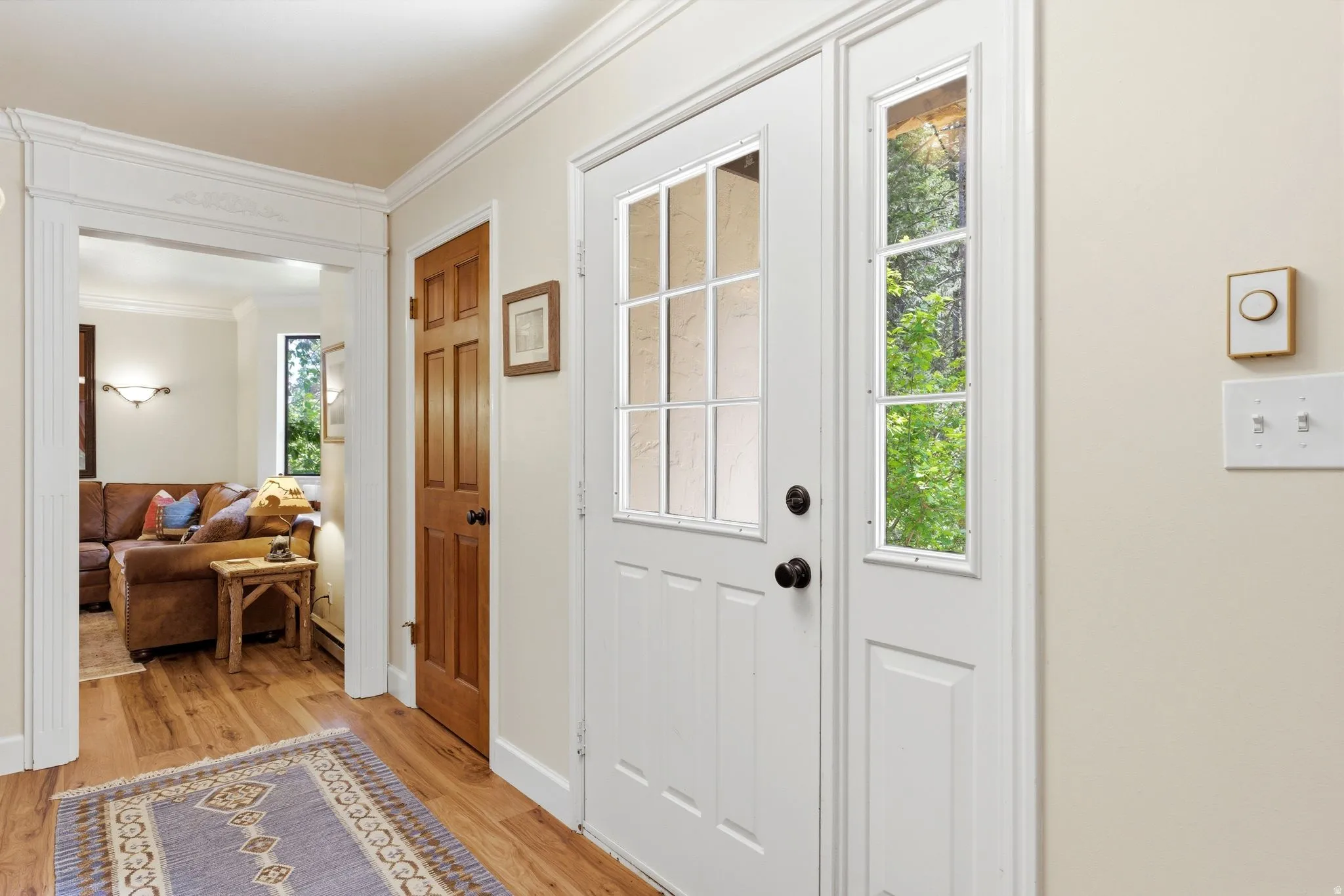 Entryway featuring a white paneled door with glass inserts and a sidelight
