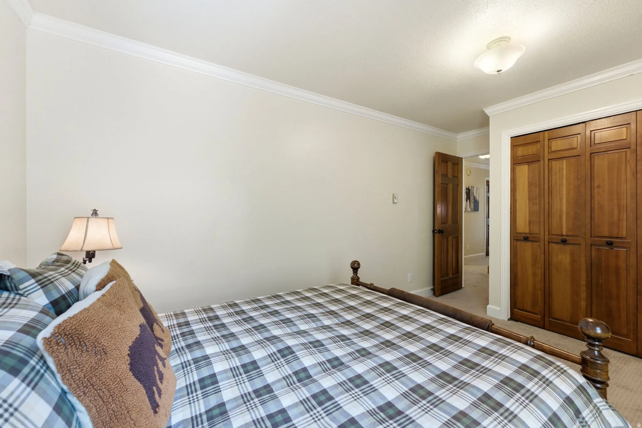 Bedroom featuring light-colored walls and crown molding