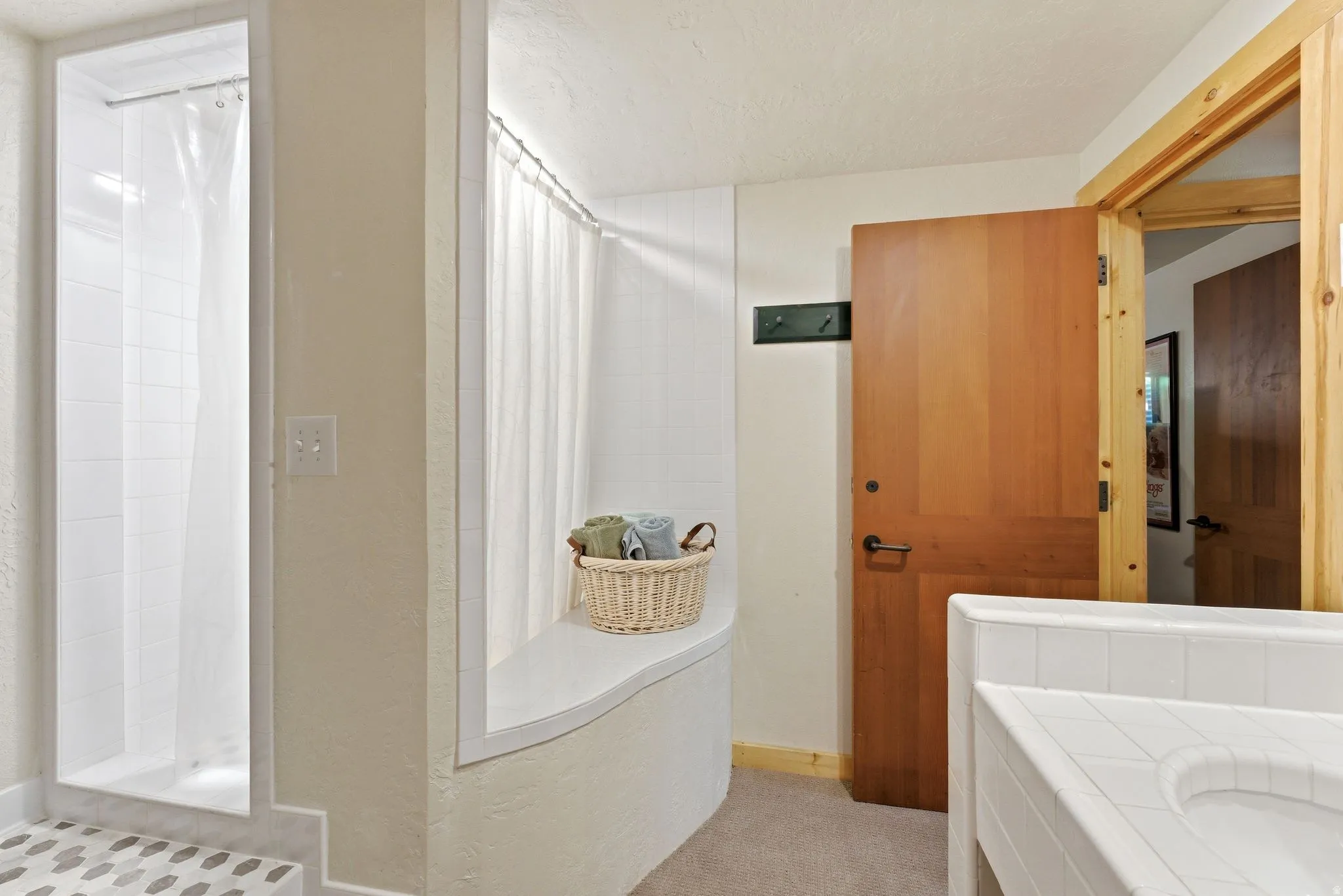 Walk-in shower with pebble-tile flooring and white subway tile surround