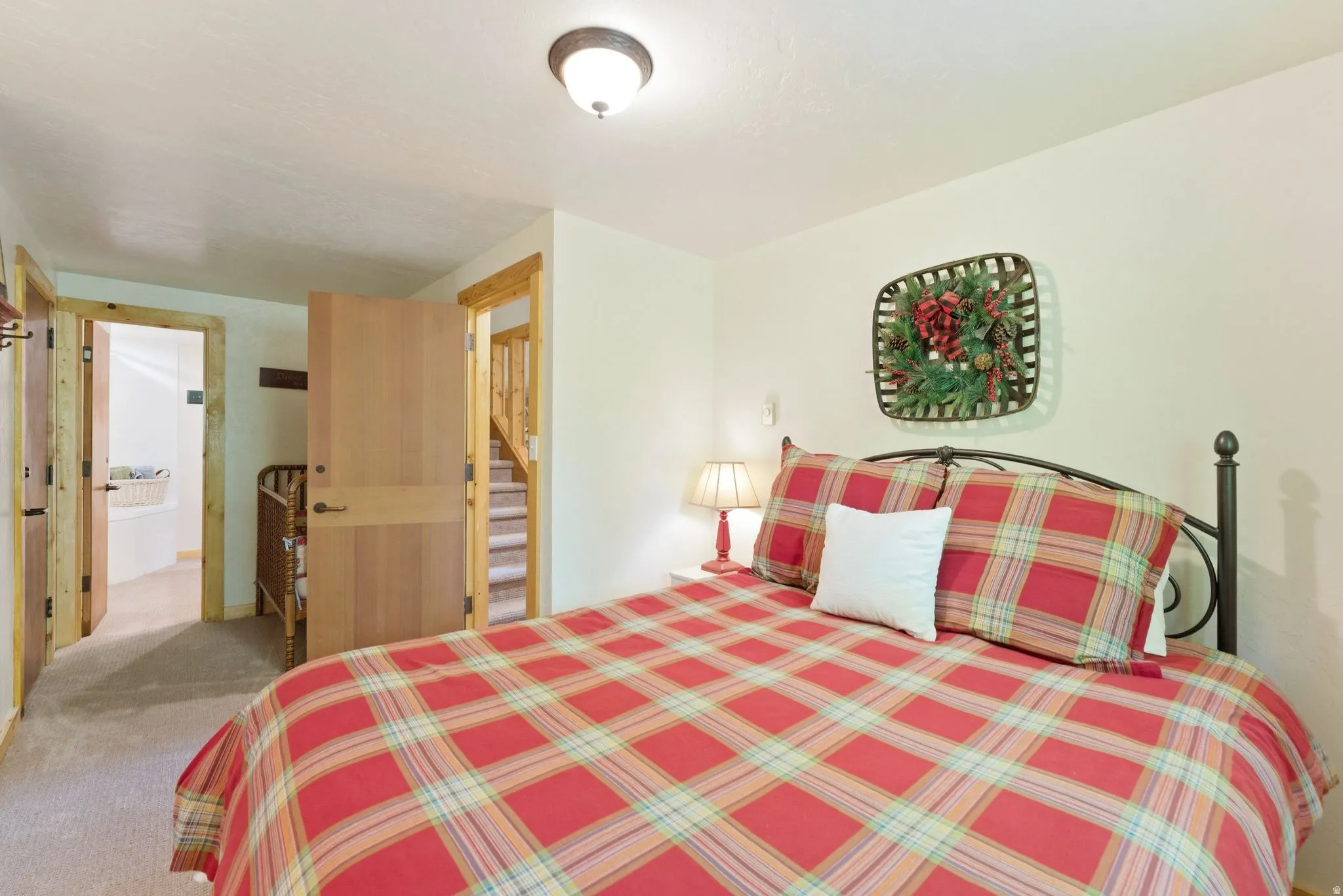 Interior room featuring light-colored walls and neutral carpeting