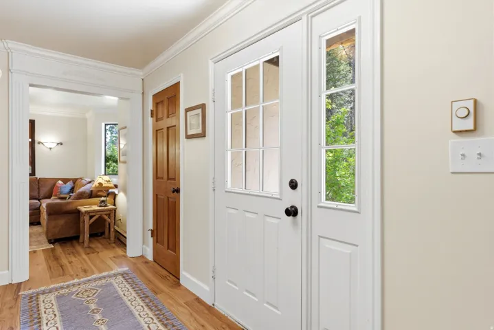Entryway featuring a white paneled door with glass inserts and a sidelight