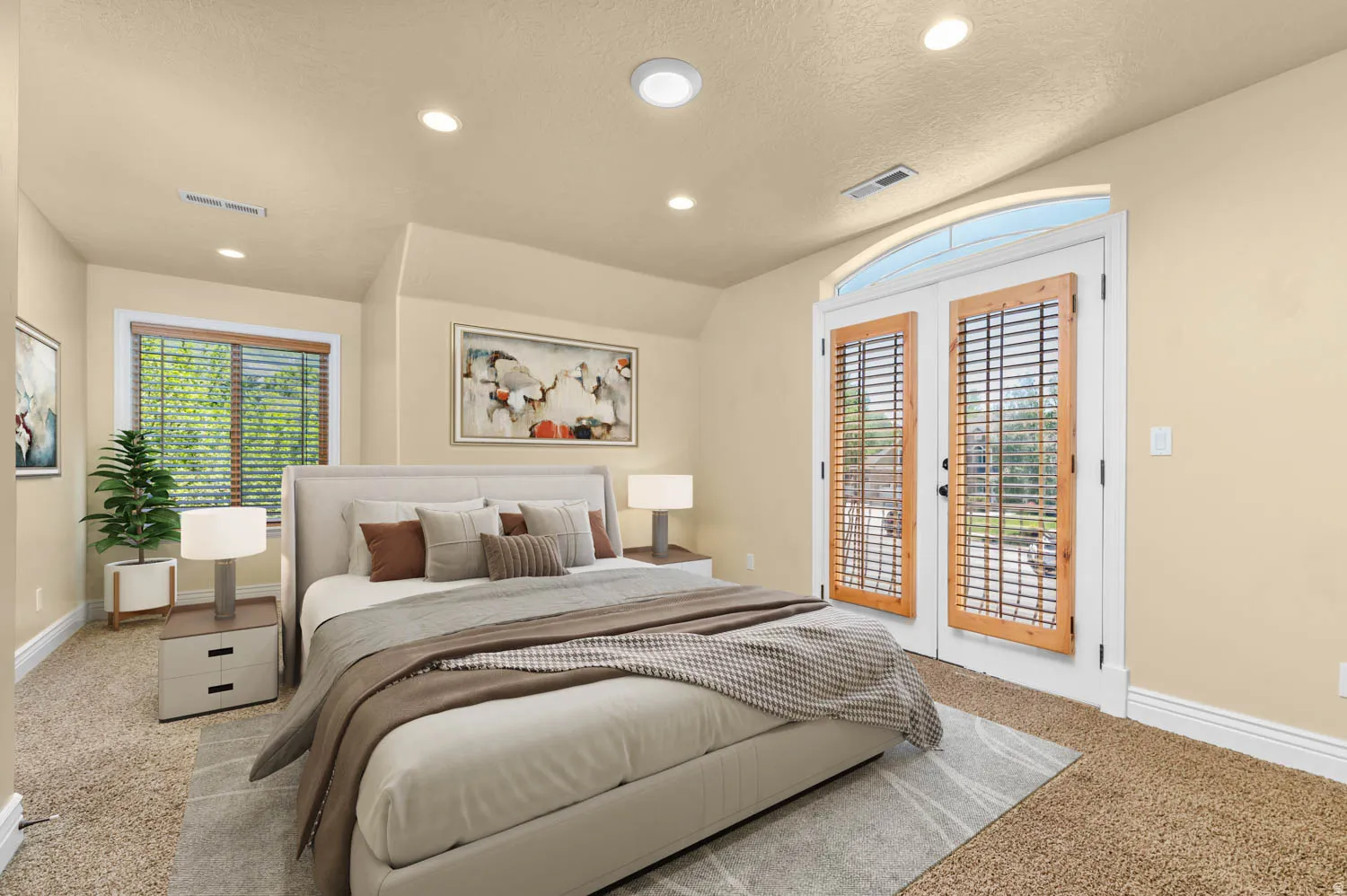Bedroom featuring warm beige wall tones, recessed lighting, and soft carpet flooring