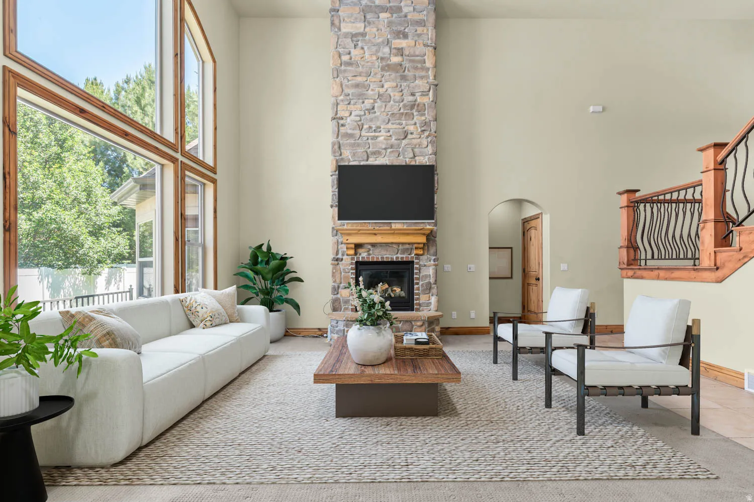 Two-story stone fireplace with wood mantel