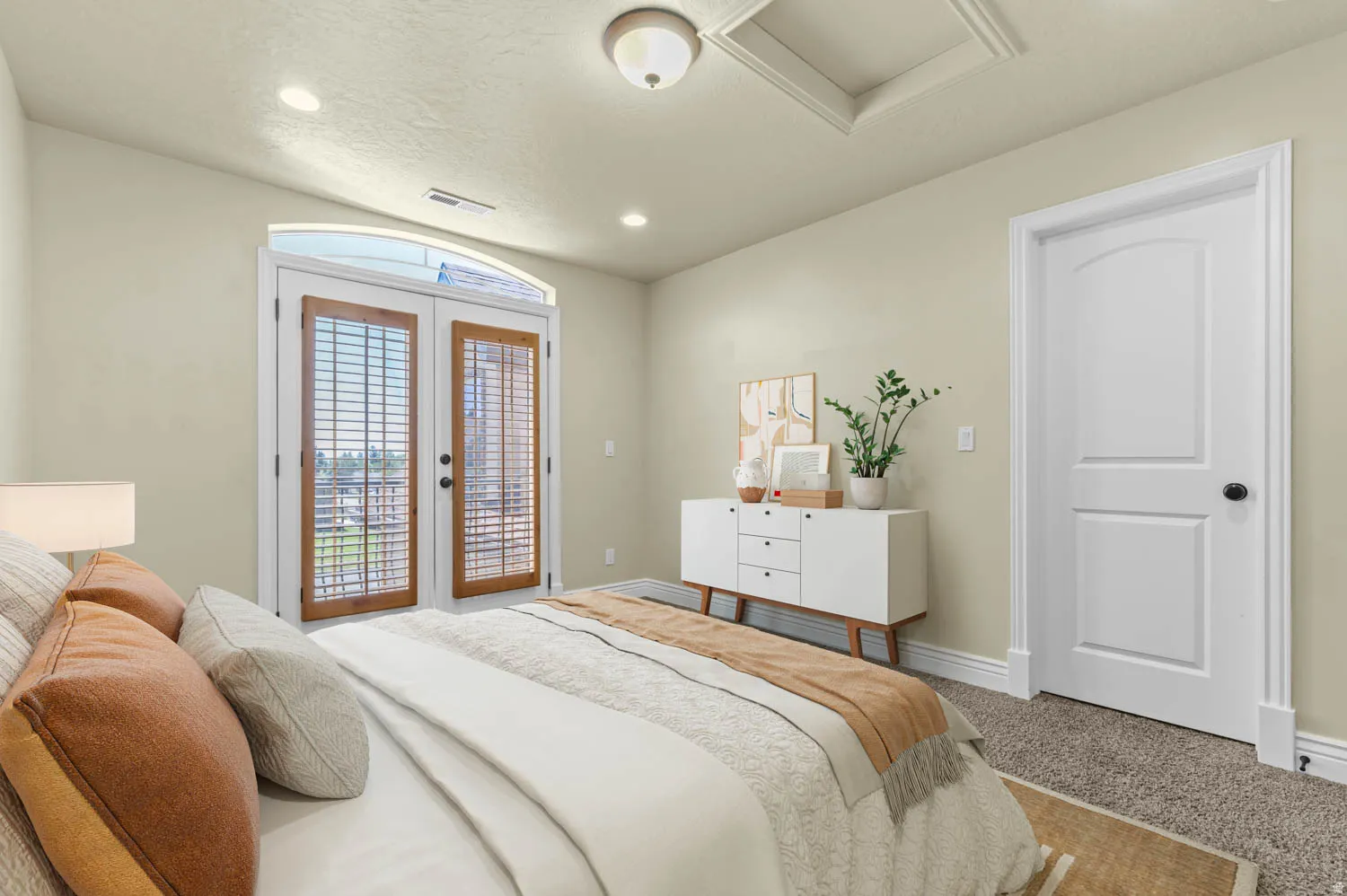 Arched French doors with interior plantation shutters