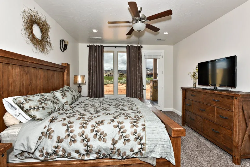 Bedroom featuring wood-finish flooring, a ceiling fan with integrated lighting, recessed lighting, and a glass-paned exterior door