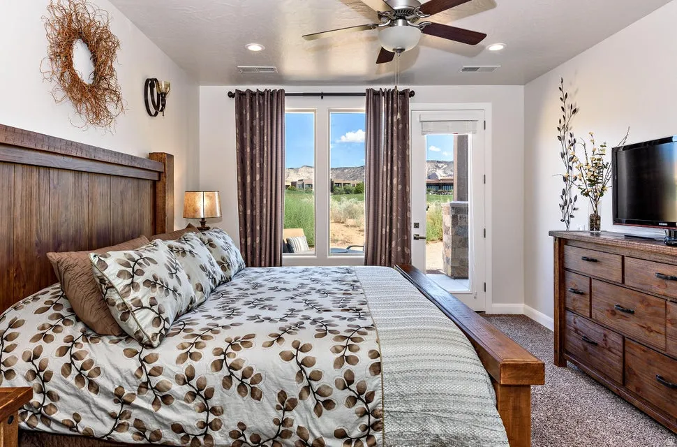 Carpeted interior space featuring a ceiling fan with light fixture, recessed lighting, and a door providing exterior access