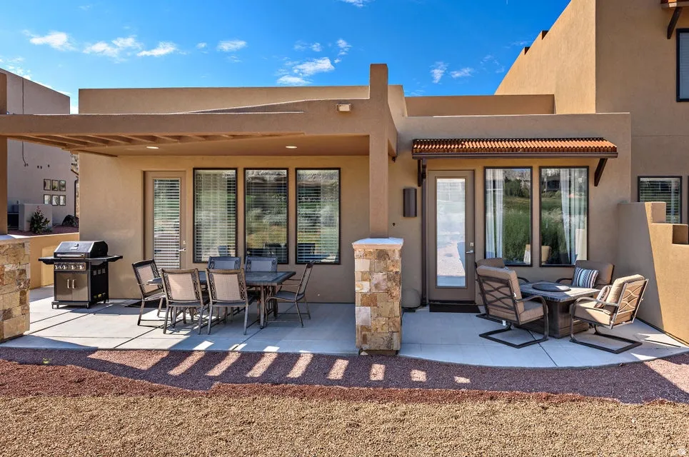 Expansive concrete patio featuring two distinct outdoor living areas