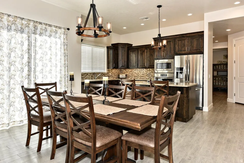 Open-concept dining area featuring light-toned wood-finish flooring