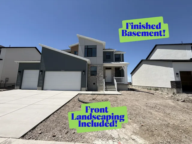 Modern architectural residence featuring multiple rooflines, a combination of siding and stone veneer, and a two-car garage