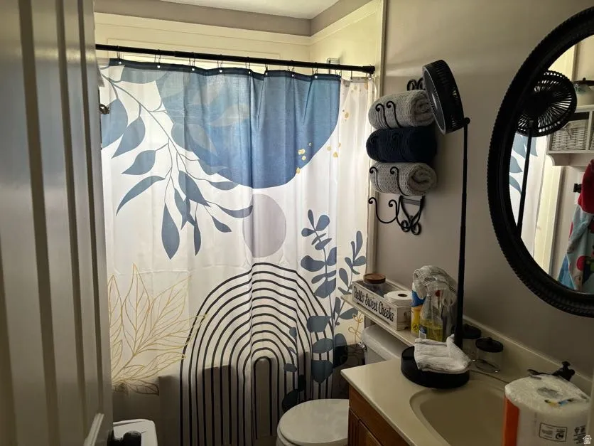 Full Bathroom featuring a built-in tub with shower, a vanity with a white countertop and integrated sink, and a wall-mounted mirror