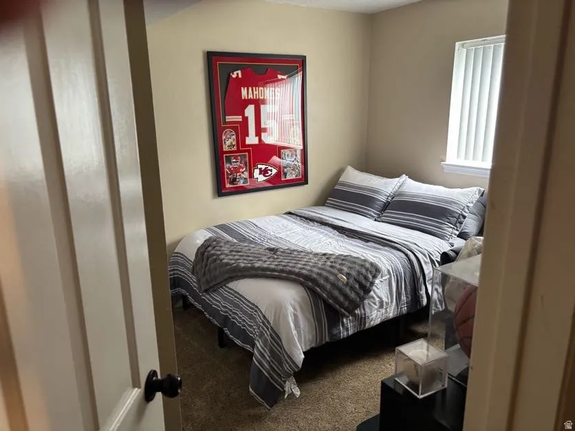 4th bedroom featuring a window with vertical blinds, neutral wall paint, and carpet flooring