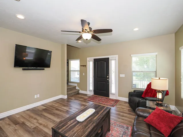 Open concept living space featuring wood-finish flooring, recessed lighting, and a ceiling fan