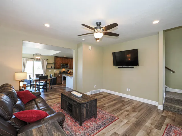 Living area featuring wood-finish flooring, recessed lighting, and a ceiling fan