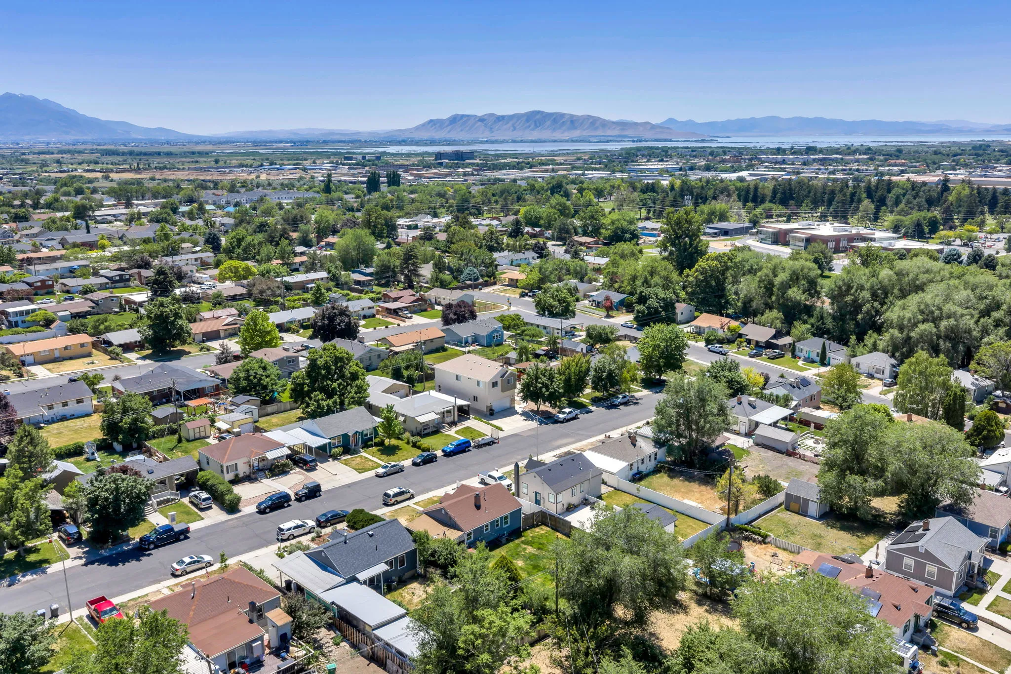 Aerial perspective showcasing a residential area with mature trees and paved streets