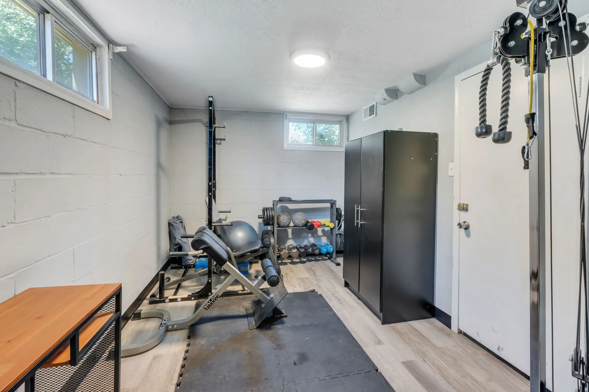 Finished interior space featuring light wood-finish flooring, recessed lighting, and perimeter block walls