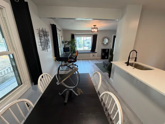 White countertops with an undermount sink and black faucet