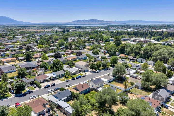 Aerial perspective showcasing a residential area with mature trees and paved streets