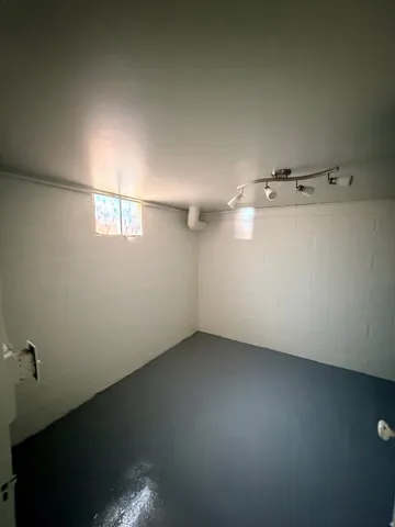 Painted concrete block walls featuring a small window