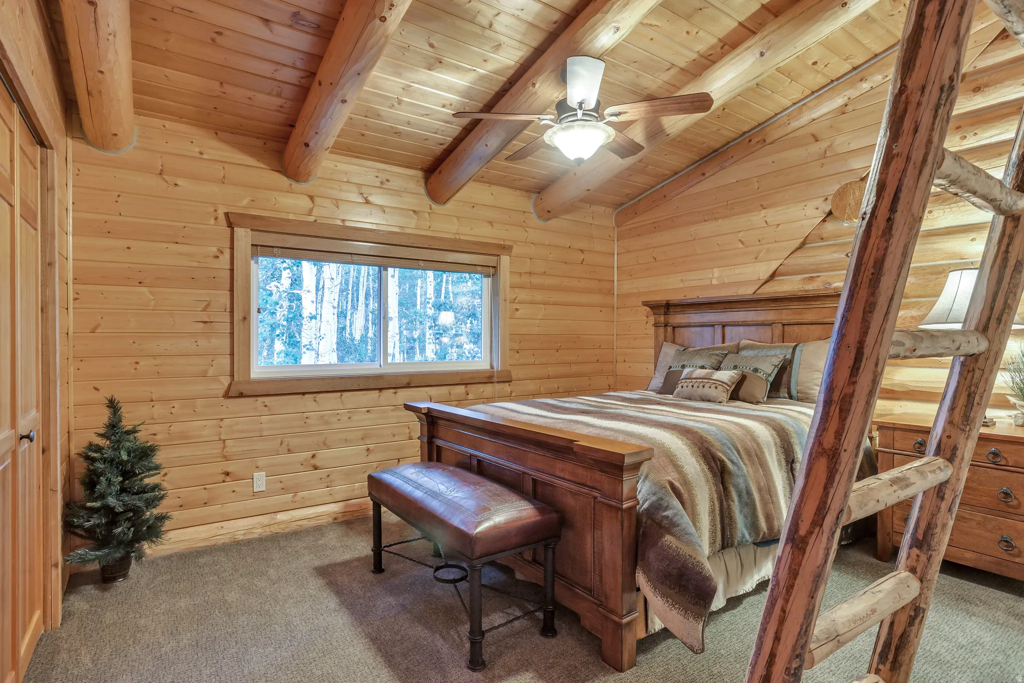 Rustic interior featuring natural wood plank walls and exposed wood ceiling beams
