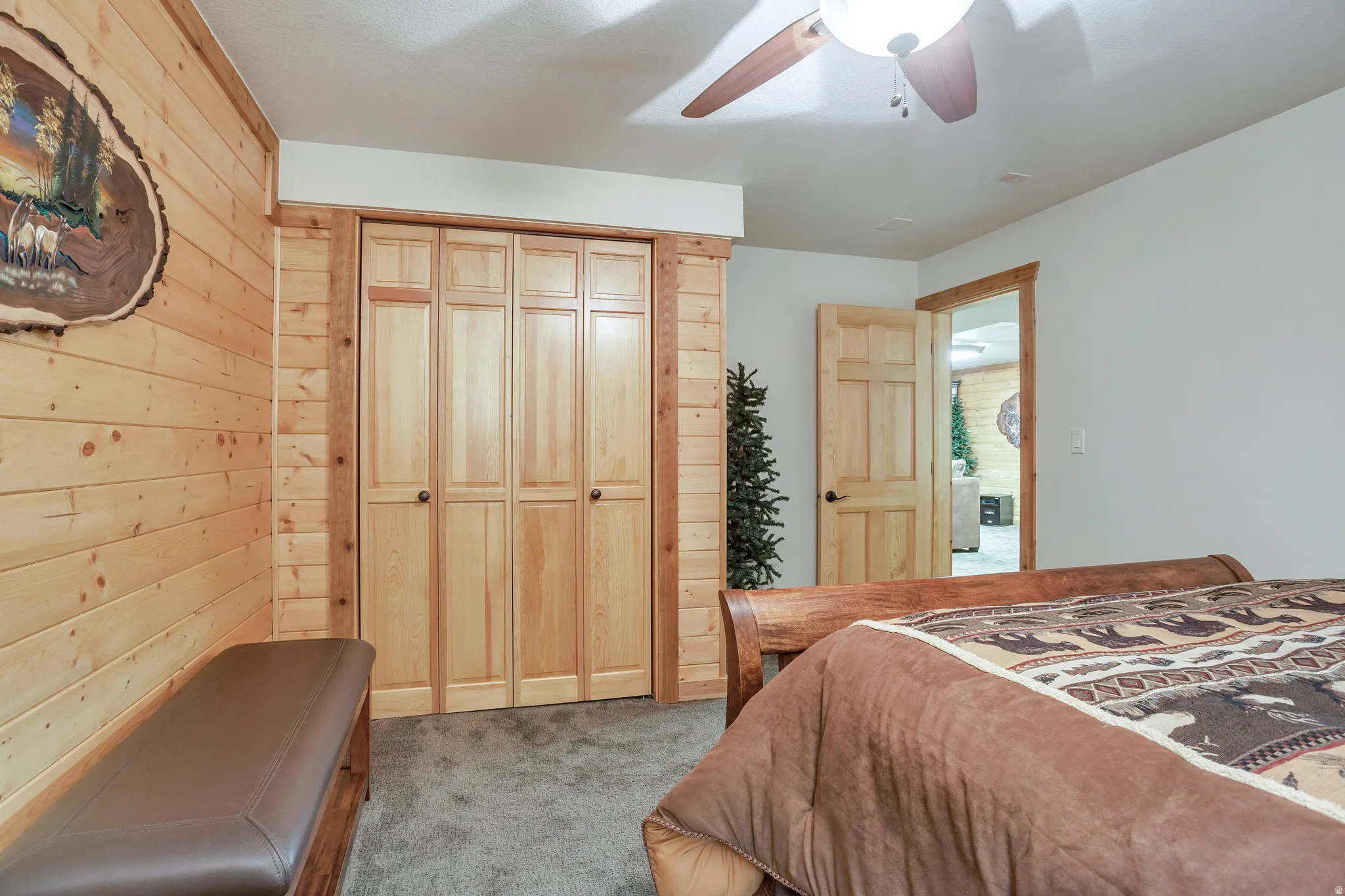 Room featuring a paneled wood accent wall, bi-fold closet doors, and recessed lighting