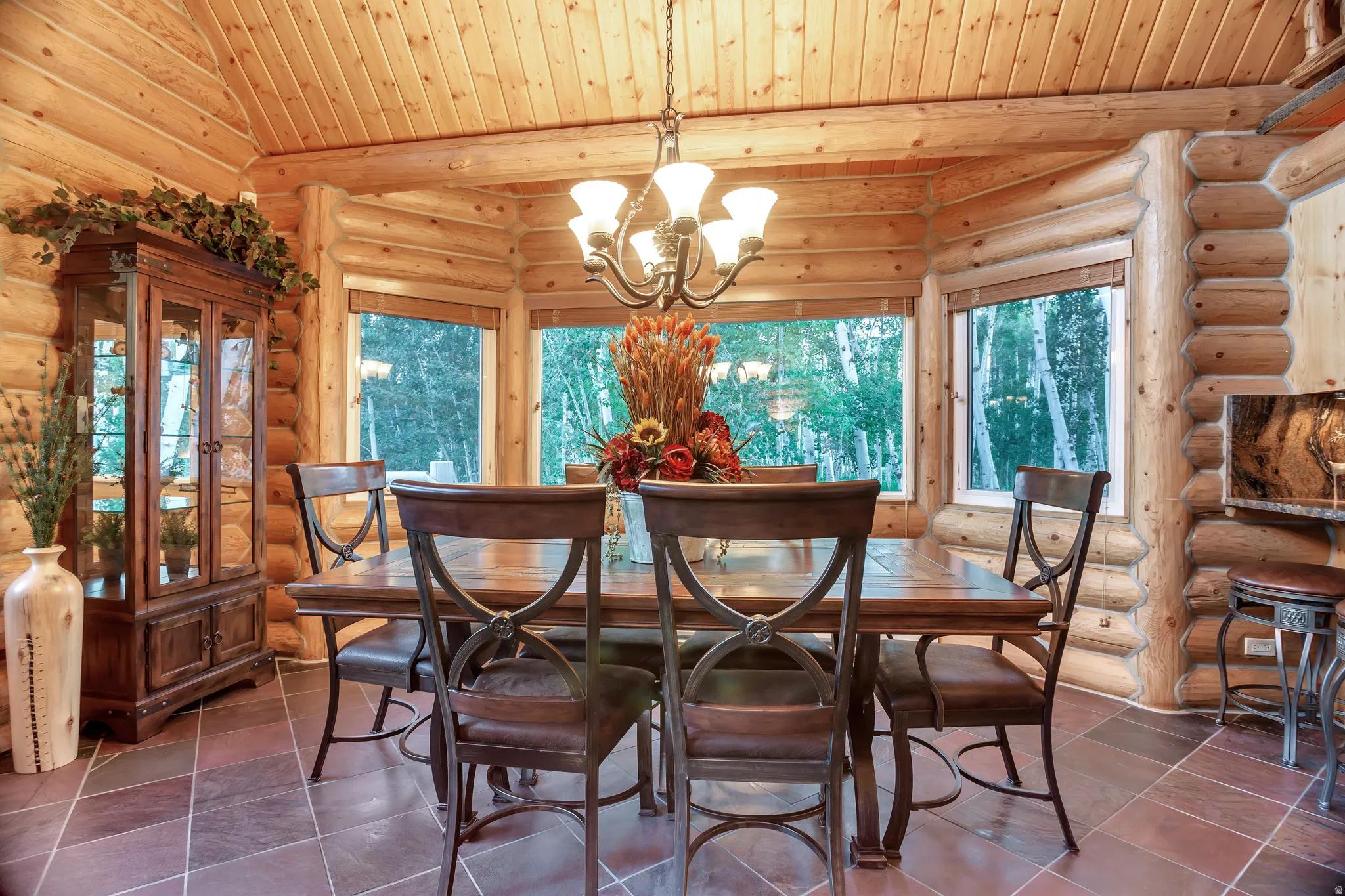 Dining area featuring a log cabin aesthetic with natural wood walls and ceiling