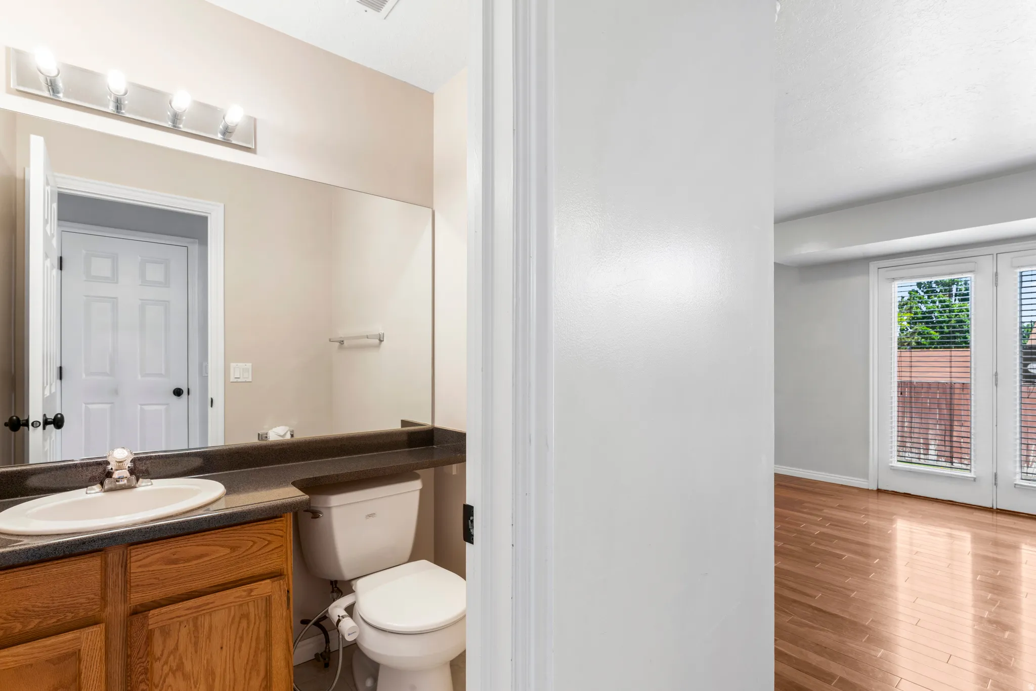 Bathroom vanity featuring a single basin sink and wood-finish cabinetry
