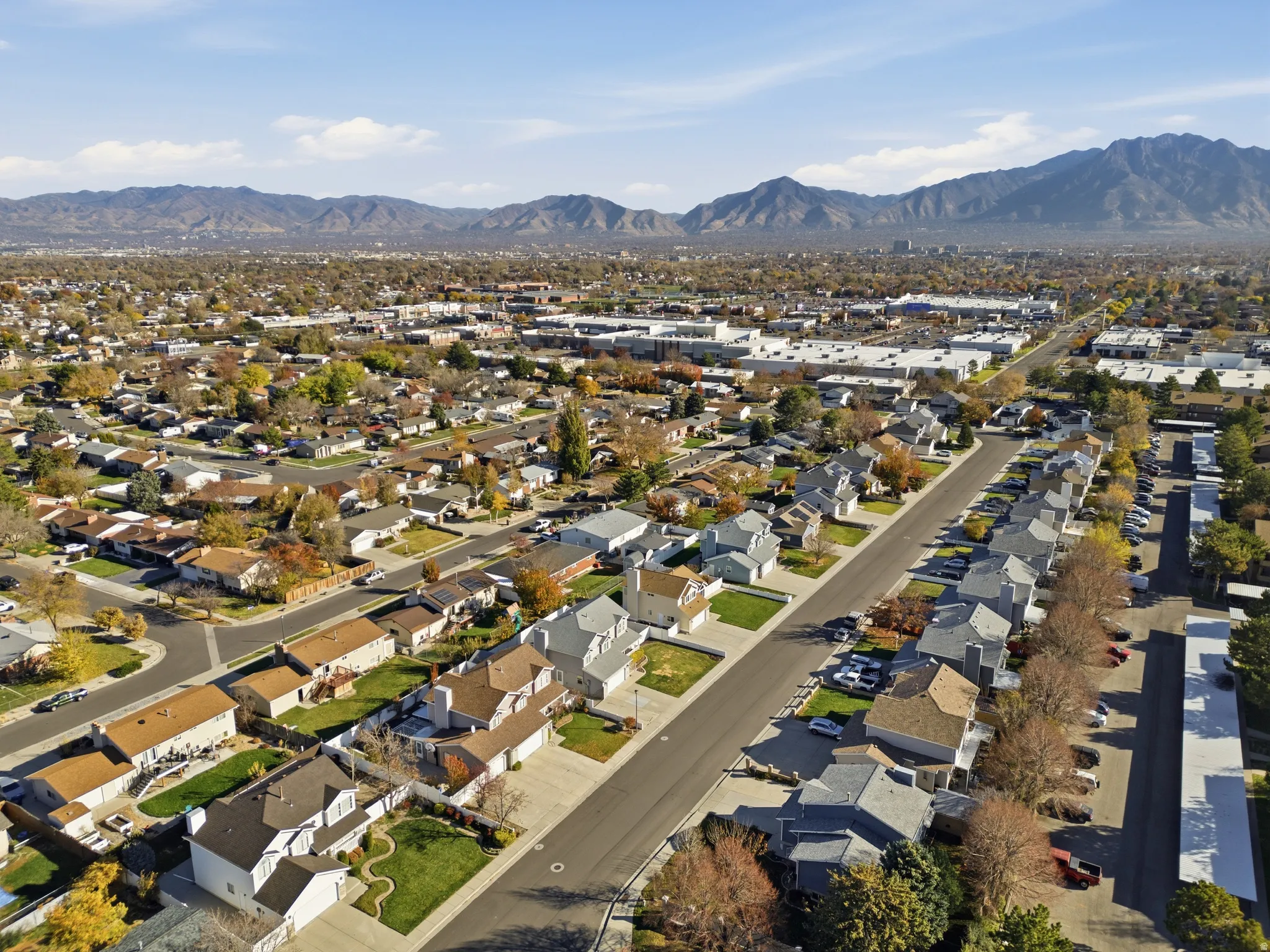 Aerial perspective of a residential neighborhood featuring detached and attached properties with asphalt shingle roofing