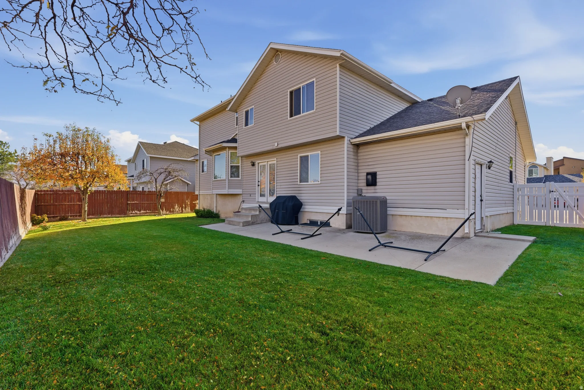Expansive green lawn with a privacy fence