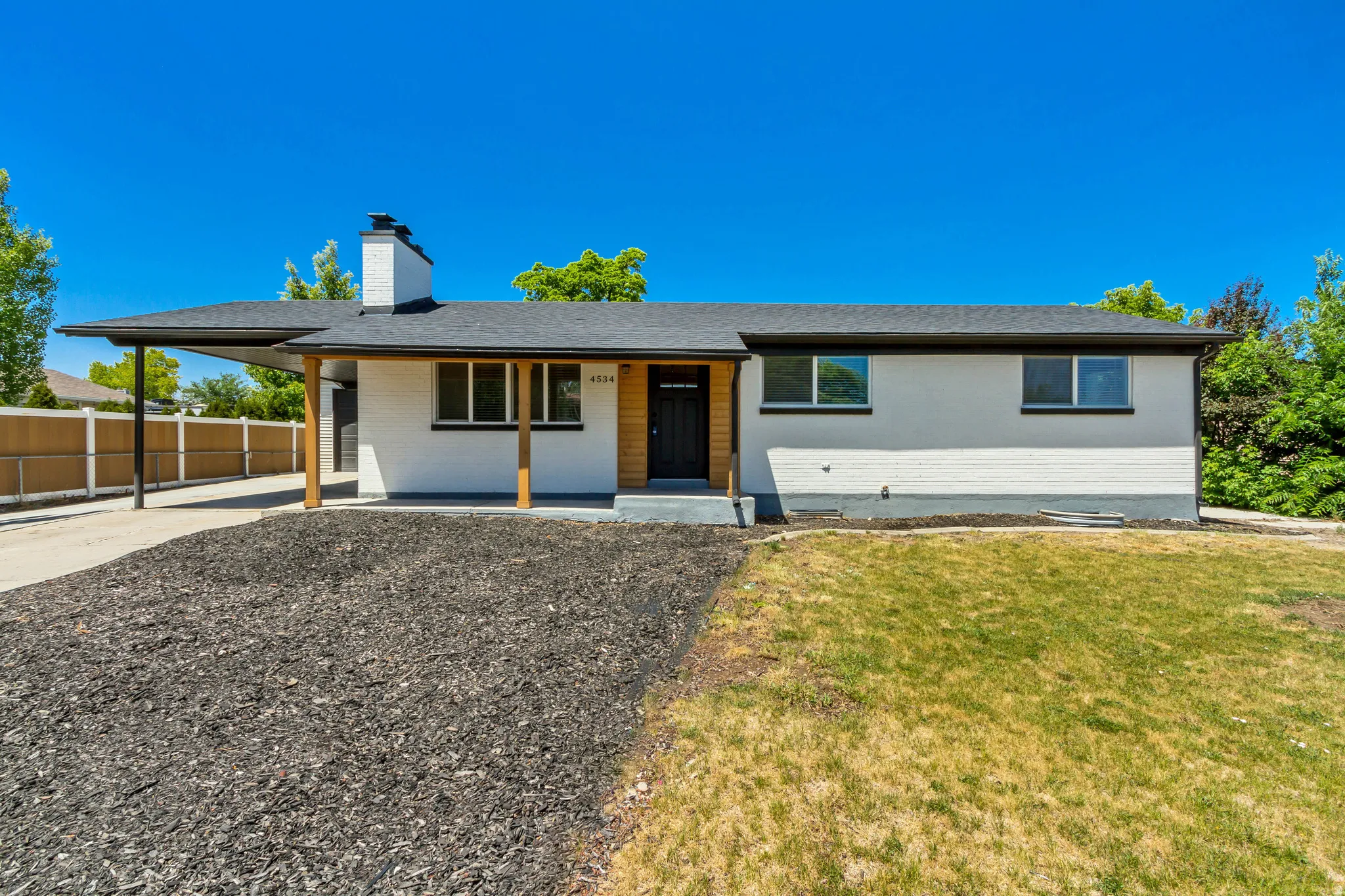Contemporary ranch-style exterior with a white painted finish